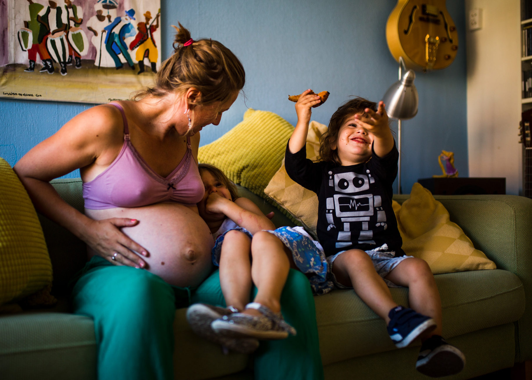 Pregnant mom playing with her children.