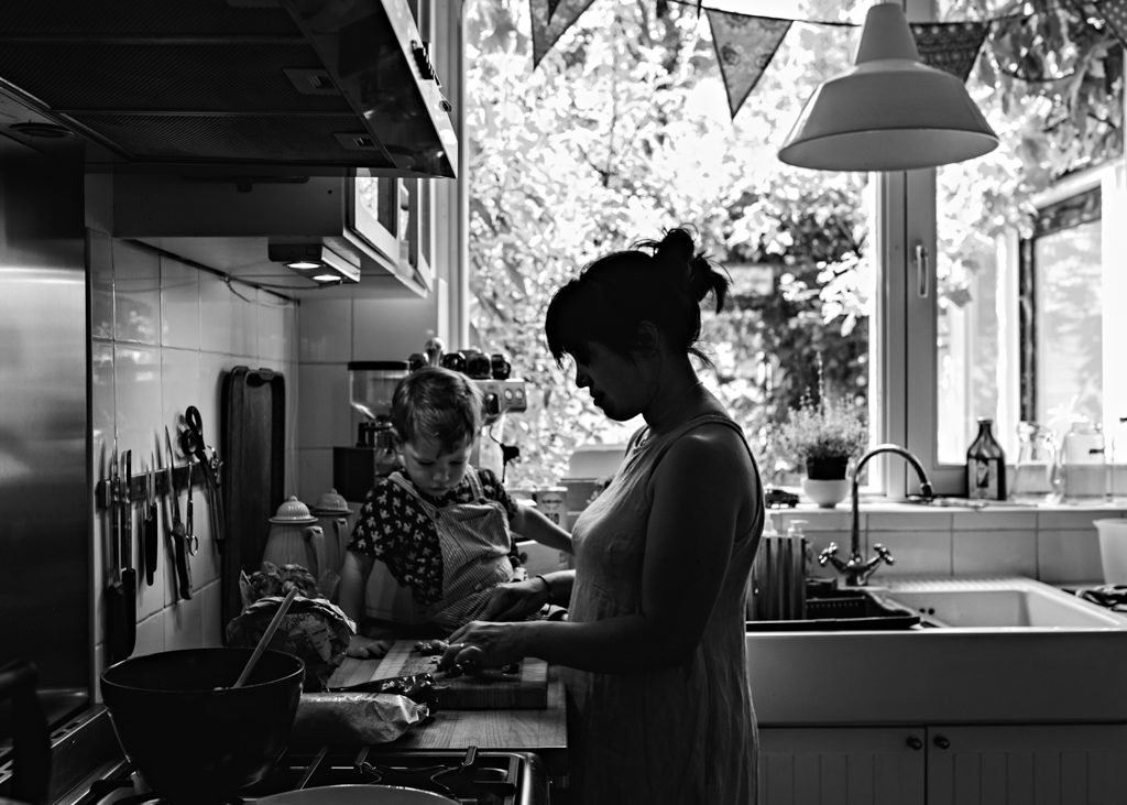 Mom cooking with her toddler on the countertop in a documentary family photoshoot in Amsterdam, Noord-Holland