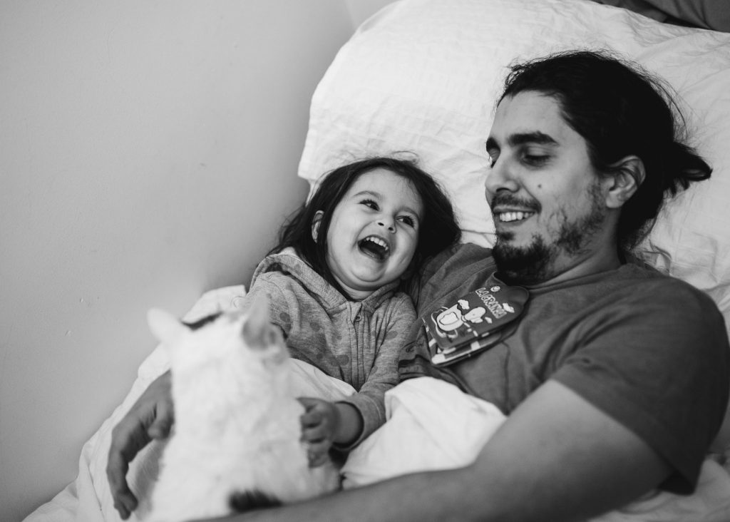 Toddler and her dad with their cat, smiling and being happy in a "Morning in your life" photoshoot, Amsterdam, Noord-Holland