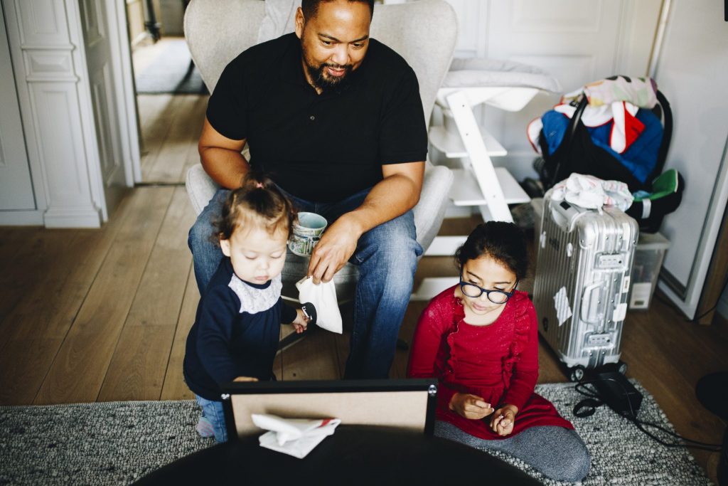 dad playing with their daughters during a morning in a documentary photo shoot in Amsterdam