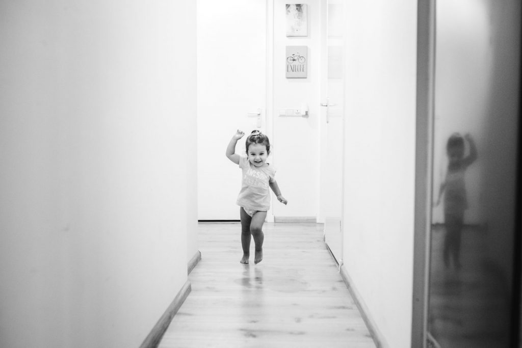 Documentary photography, toddler running in the kitchen