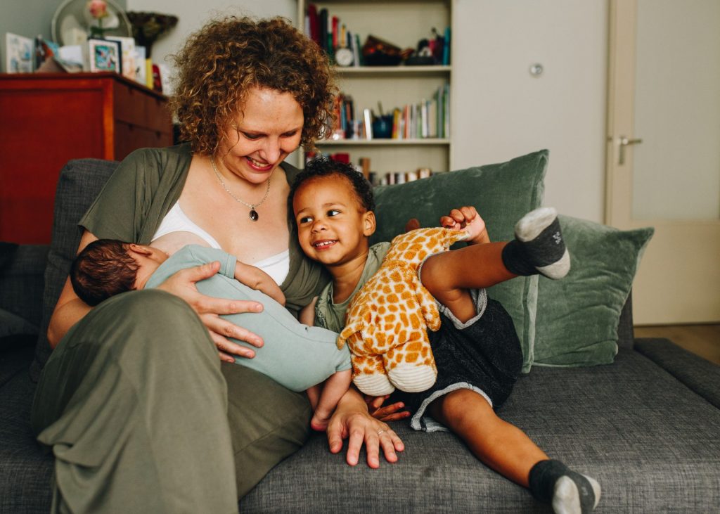 Documentary photo shoot at home, family and newborn photographer in Amsterdam. Breastfeeding on demand while having a toddler