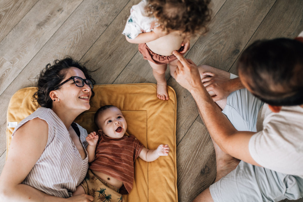 Family playing on the floor of their living room