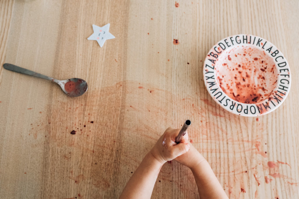 details of a messy table after a toddler eat his breakfast