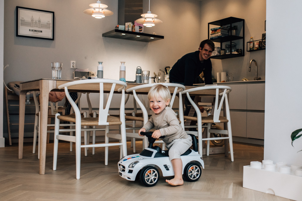 Toddler playing with his dad in the kitchen