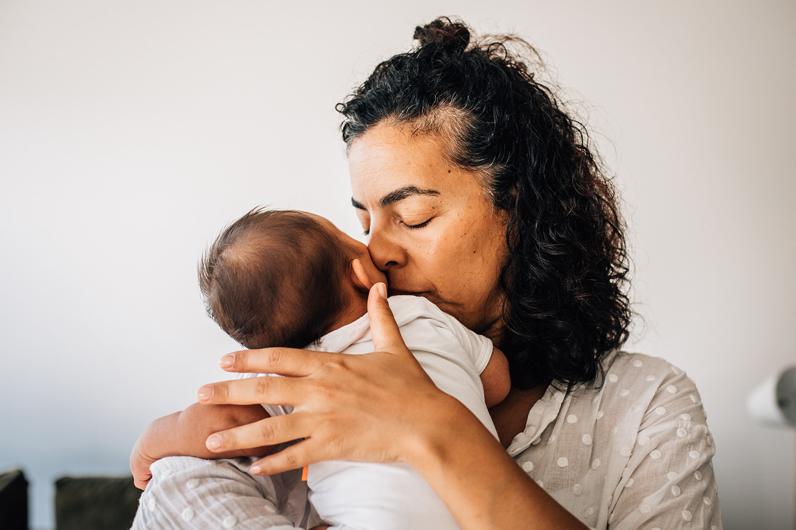 Mother smelling her newborn's head