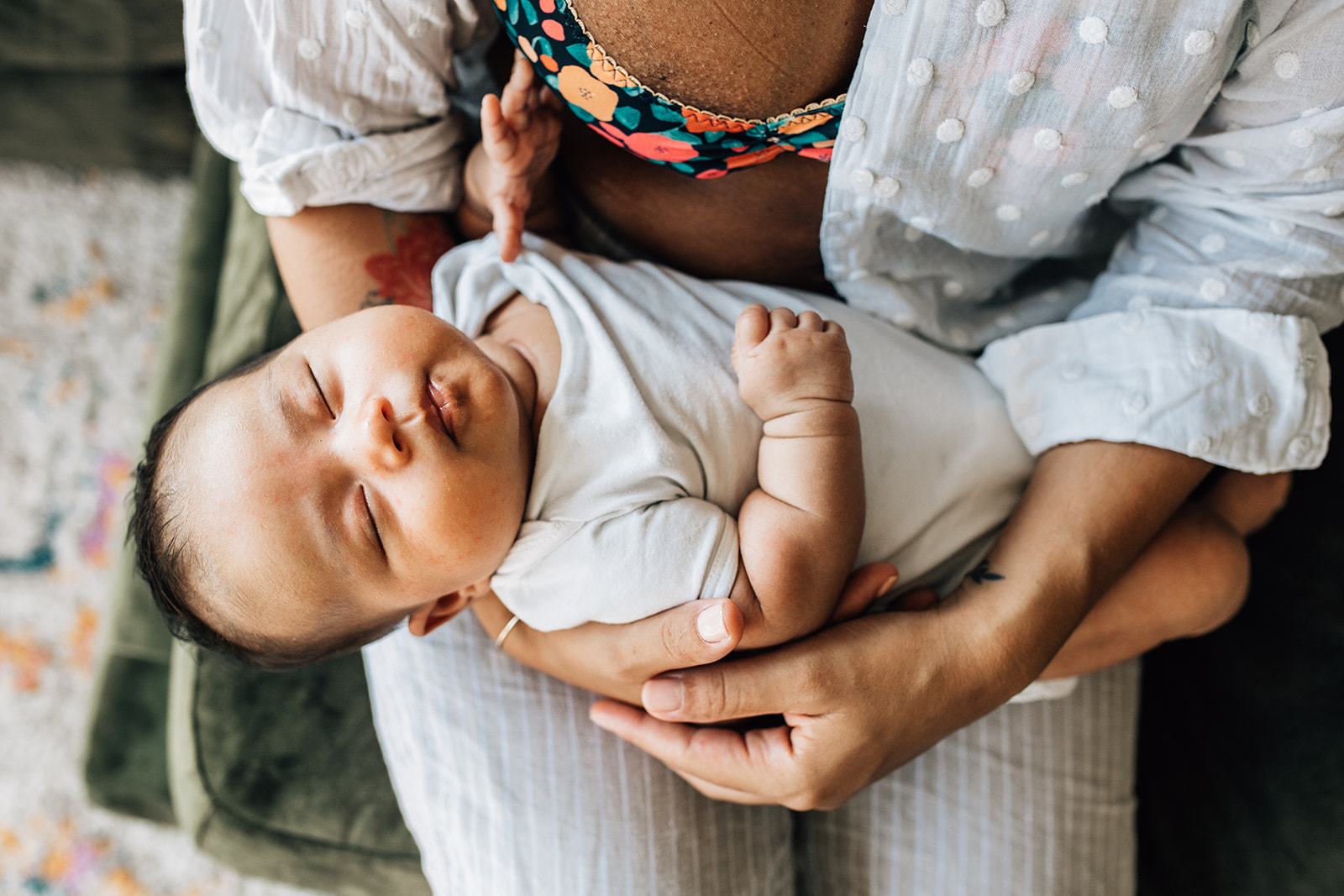 baby resting on her mom's lap after being fed